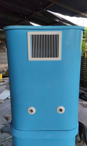 Front view of a blue plug and play pool filtration system with ventilation grille and dual outlet ports.