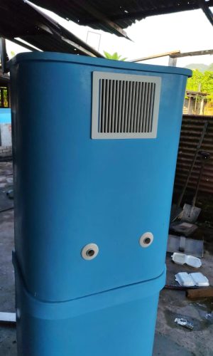 Close-up of blue plug and play pool filter casing with ventilation vent and water pipe ports.