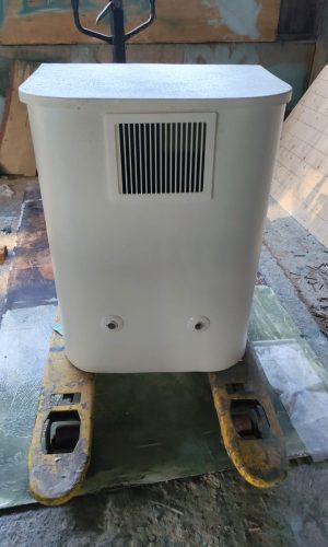 Front elevation of a white plug and play pool filter system with upper ventilation grill and connection ports.